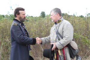 C'Ville 2013 Grant and Chalmers (Larry McCluney Jr.) shake hands close up Photo by Joe Krisle